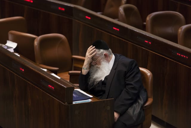 Israeli MKs of the United Torah Judaism party Meir Porush reacts as he sits in the plenum as the Knesset approves Yesh Atid's draft bill on first reading early Tuesday morning, in the Knesset, Israel's Parliament, in Jerusalem, early July 23, 2013 (photo credit: FLASH90)