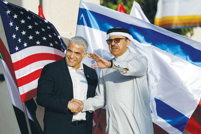  BAHRAIN’S FOREIGN Minister Abdullatif bin Rashid Al Zayani and then-foreign minister Yair Lapid meet at The Negev Summit, also attended by the US, UAE, Morocco and Egypt, last year. It’s likely the UAE and Bahrain received the OK from Riyadh to sign the Abraham Accords, says the writer.  (photo credit: AMIR COHEN/REUTERS)