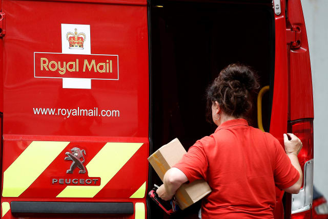  A postal worker makes a delivery in London (photo credit: REUTERS)