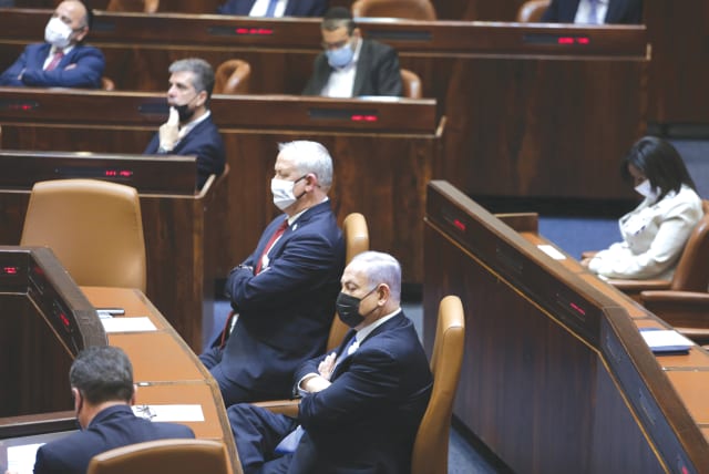  PRIME MINISTER Benjamin Netanyahu and then-defense minister  Benny Gantz sit at the head of the government table in the Knesset plenum, in 2021 (photo credit: ALEX KOLOMOISKY/FLASH90)