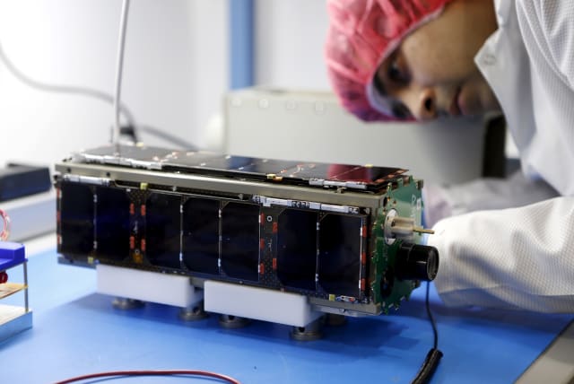  Spacecraft hardware engineer Anubhav Thakur performs a test on one of Spire's Lemur 2-2.0 satellites during a tour of Spire's nano-satellite facility in San Francisco, California January 6, 2016.  (photo credit: REUTERS/BECK DIEFENBACH)