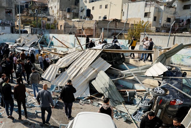  Palestinians inspect the damage following an Israeli raid in Jenin in the West Bank January 26, 2023.  (photo credit: REUTERS/RANEEN SAWAFTA)