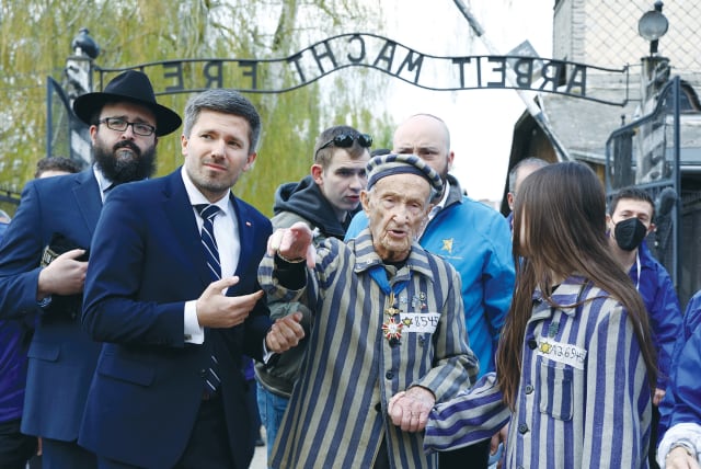  HOLOCAUST SURVIVOR Edward Mosberg and his relatives take part in the annual International March of the Living through the grounds of the former Auschwitz death camp, in Oswiecim, Poland, last year. (photo credit: KACPER PEMPEL/REUTERS)