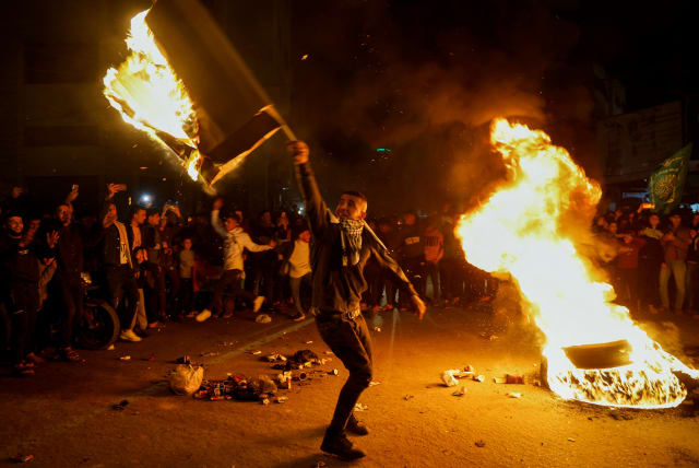  Palestinians celebrate following Jerusalem's shooting attack, in Gaza City January 27, 2023. (photo credit: REUTERS/MOHAMMED SALEM)