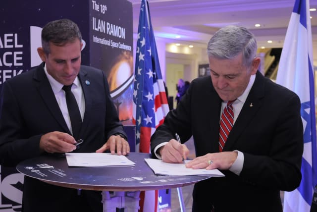  ISA director Uri Oron (on the left) and NASA Associate Administrator, Robert (Bob) Cabana (on the right) sign a statement of intent to cooperate on the Beresheet2 lunar mission, on February 1, 2023. (photo credit: RONEN HORESH/GPO)