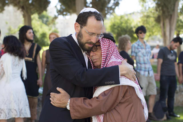  RABBI DR. YAKOV NAGEN: Simply loves people. Pictured: Embracing Haj Ibrahim Ahmad Abu el-Hawa, clan chief whose family has been residing in the Jerusalem area for many generations.  (photo credit: Sarah Schuman/Flash90)
