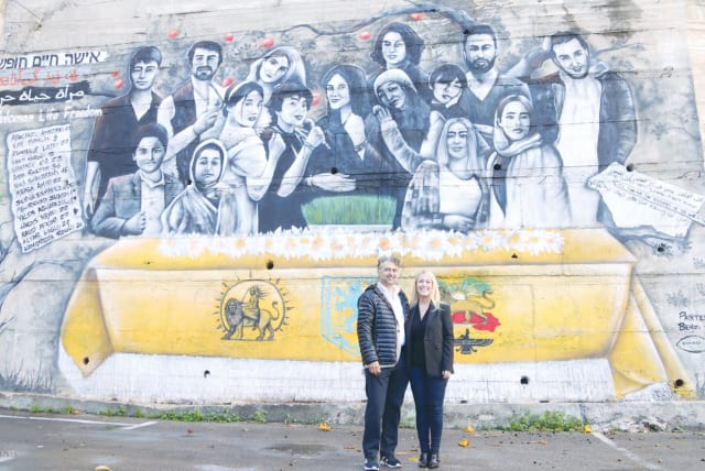  HOOMAN KHALILI (left) and the writer stand in front of the mural.  (photo credit: Shadi Obied)