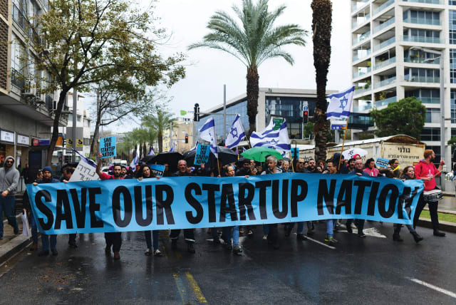  WORKERS FROM the hi-tech sector protest against the proposed changes to the legal system, in Tel Aviv, on Tuesday. (photo credit: TOMER NEUBERG/FLASH90)