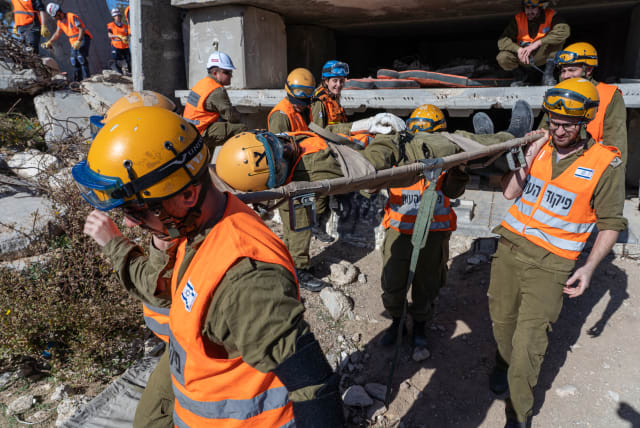  Members of the Knesset Honor Guard, Home Front Command, Firefighters, IDF and Israel's Magen David Adom Emergency Medical Services participate in an emergency drill simulating an earthquake near Ashkelon,  on December 19, 2019. (photo credit: YANIV NADAV/FLASH90)