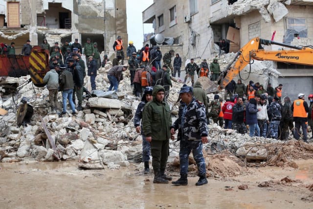  Rescuers search for survivors at the site of a collapsed building, following an earthquake, in Hama, Syria February 6, 2023.  (photo credit: REUTERS/YAMAM AL SHAAR)