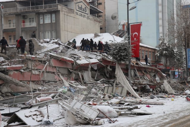 Rescuers carry out a person from a collapsed building after an earthquake in Malatya, Turkey February 6, 2023. (photo credit: Ihlas News Agency (IHA) via REUTERS)
