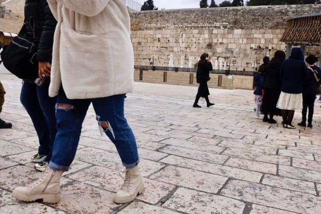 Women are seen walking across the Western Wall site in a photo taken February 9, 2023  (photo credit: MARC ISRAEL SELLEM/THE JERUSALEM POST)