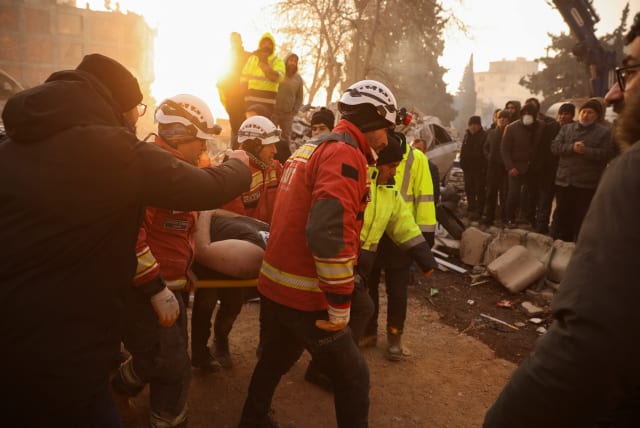  Rescuers carry 30-year-old survivor Omer Faruk Telbisoglu on a stretcher after he was rescued, in the aftermath of a deadly earthquake in Kahramanmaras, Turkey February 10, 2023.  (photo credit: REUTERS/STOYAN NENOV)