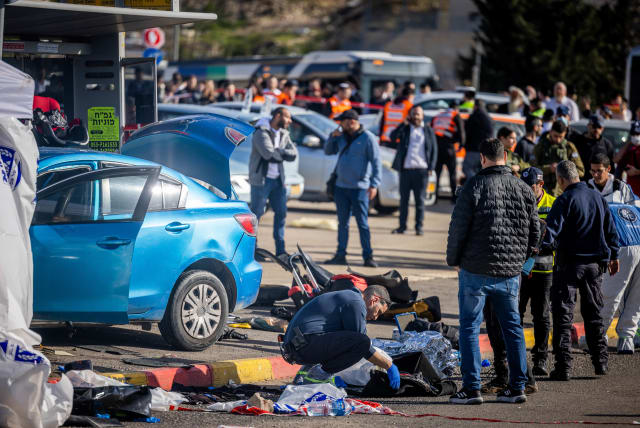  Rescue and Police at the scene of the deadly car-ramming attack near the Ramot junction, in Jerusalem on February 10, 2023.  (photo credit: YONATAN SINDEL/FLASH90)