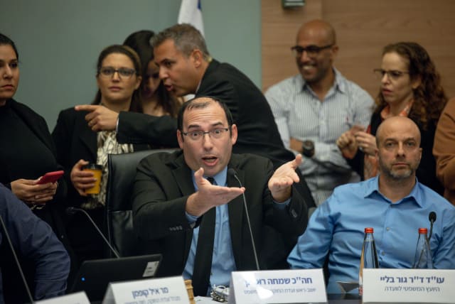  MK Simcha Rothman is seen gesturing amid a chaotic session of the Knesset Law and Constitution Committee in Jerusalem during a debate on judicial reform, on February 13, 2023. (photo credit: YONATAN SINDEL/FLASH90)