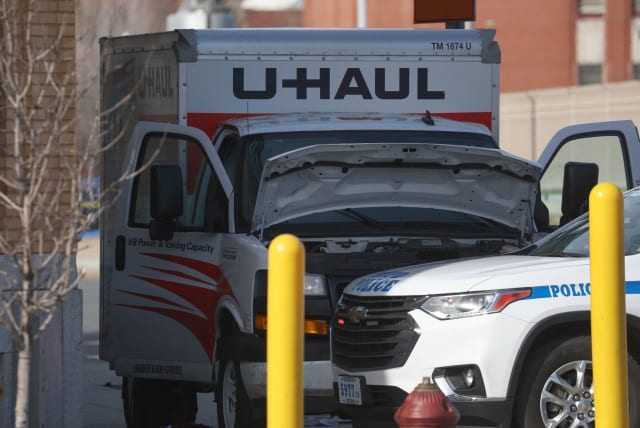  A New York Police Department vehicle blocks a U-Haul rental vehicle, where according to media reports, a man struck multiple people and the NYPD took the driver into custody, near the Battery tunnel in the Brooklyn borough of New York City, US, February 13, 2023.  (photo credit: REUTERS/SHANNON STAPLETON)