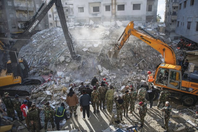  RESCUE WORKERS search for earthquake survivors among the rubble in Latakia Province, Syria, Feb. 7. (photo credit: AFP VIA GETTY IMAGES)