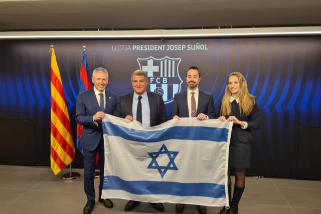 Israeli diplomats presented FC Barcelona's president Laporta with an Israeli flag on February 16, 2023, recognizing FC Barcelona's years of support for and friendship with Israel.  (photo credit: ISRAELI EMBASSY IN SPAIN)