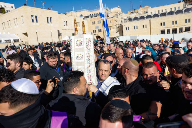  MK Gilad Kariv holds a Torah Scroll during Rosh Hodesh prayer of women of the wall, at the Western Wall in Jerusalem Old City, February 22, 2023. (photo credit: ERIK MARMOR/FLASH90)