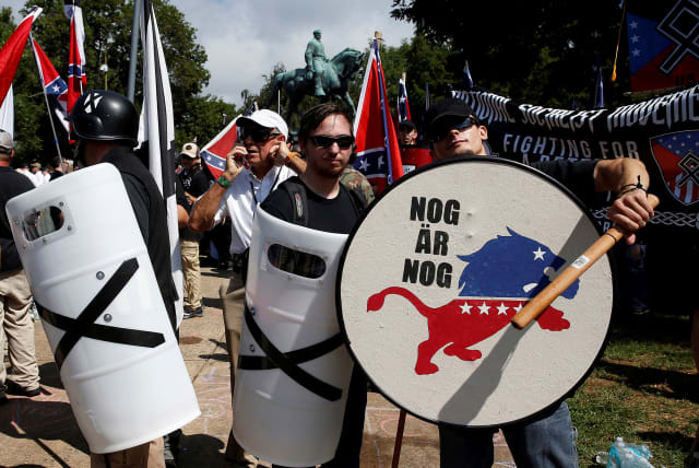 White supremacists stand behind their shields at a rally in Charlottesville, Virginia, US, August 12, 2017. (photo credit: REUTERS/JOSHUA ROBERTS)