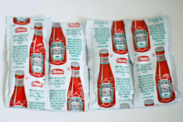 Packets of Heinz ketchup are shown in this photo illustration taken April 7, 2021. (photo credit: REUTERS/MIKE BLAKE/ILLUSTRATION)