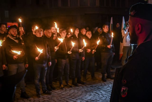  Far-right groups and nationalists carry torches and march to commemorate the Nazi-era Bulgarian General Hristo Lukov in Sofia, Bulgaria, Feb. 12, 2022.  (photo credit: Georgi Paleykov/NurPhoto via Getty Images)
