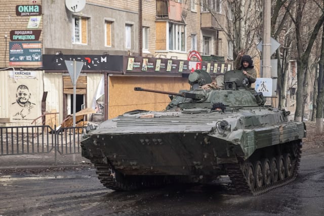 Ukrainian service members ride a BMP-2 infantry fighting vehicle an empty street, as Russia's attack on Ukraine continues, in the frontline city of Bakhmut, Ukraine February 27, 2023. (photo credit: REUTERS/YEVHEN TITOV)