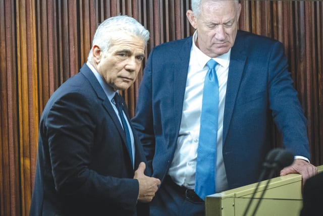  MKS YAIR Lapid and Benny Gantz stand next to each other during a debate in the Knesset plenum last week.  (photo credit: YONATAN SINDEL/FLASH90)