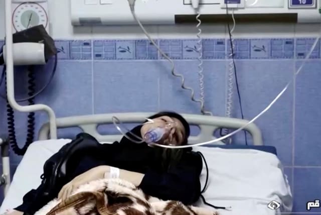  A young woman lies in hospital after reports of poisoning at an unspecified location in Iran in this still image from video from March 2, 2023. (photo credit: WANA/REUTERS)