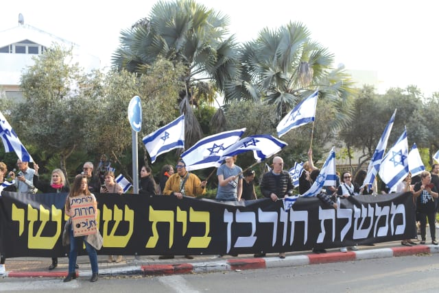  DEMONSTRATORS OPPOSING the government’s proposed judicial overhaul protest outside President Isaac Herzog’s home in Tel Aviv, last Friday. The large banner accuses the government of being the destroyer of the ‘Third temple’ (photo credit: TOMER NEUBERG/FLASH90)