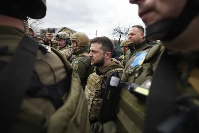  Ukrainian President Volodymyr Zelensky standing among Ukrainian soldiers (photo credit: The Berkshire Edge)