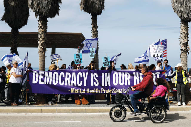  DEMONSTRATORS OUTSIDE the US Consulate in Tel Aviv on March 7 call on the US to intervene to stop the government’s judicial overhaul.  (photo credit: AMMAR AWAD/REUTERS)