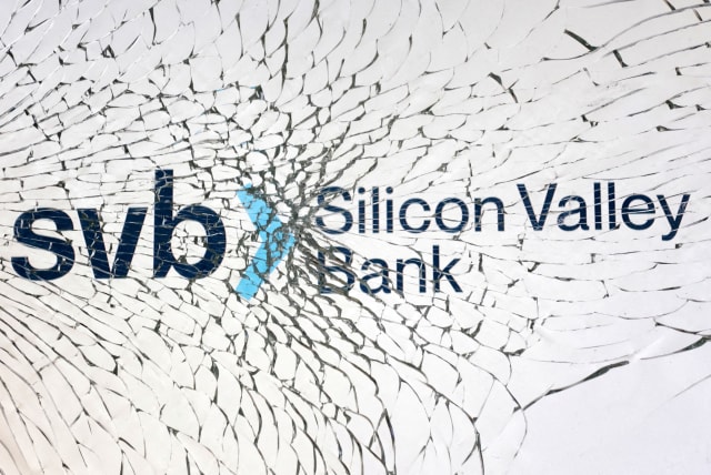 SVB (Silicon Valley Bank) logo is seen through broken glass in this illustration taken March 10, 2023.  (photo credit: REUTERS/DADO RUVIC/ILLUSTRATION)