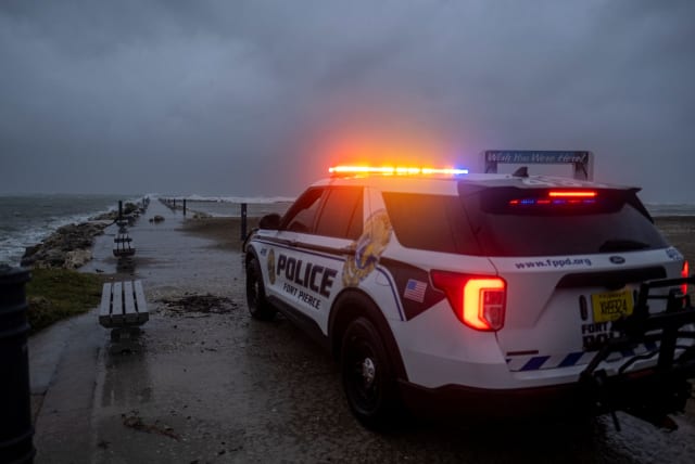  A police car blocks the entrance to the Inlet State Park before the expected arrival of Hurricane Nicole in Fort Pierce, Florida, US November 9, 2022. (photo credit: REUTERS/RICARDO ARDUENGO)