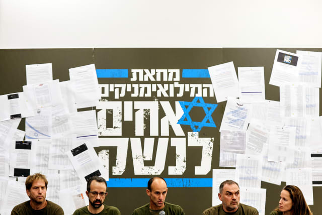  Members of Israel's 'Brothers in Arms' reservist protest group hold a news conference as Prime Minister Benjamin Netanyahu's coalition government presses on with its judicial overhaul, in Herzliya near Tel Aviv, Israel, March 21, 2023 (photo credit: REUTERS/AMIR COHEN)