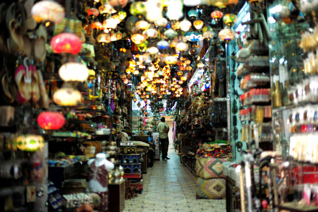  A visitor looks at traditional light-shop in local souq at Bab al Bahrain in Manama, Bahrain June 27, 2018.  (photo credit: HAMAD I MOHAMMED/REUTERS)