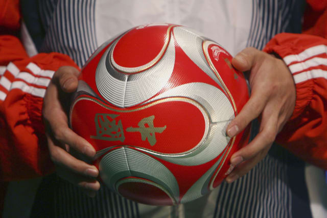  An athlete holds the official ball for the 2008 Beijing Olympics football match during its launching ceremony in Beijing January 26, 2008.  (photo credit: REUTERS/STRINGER)