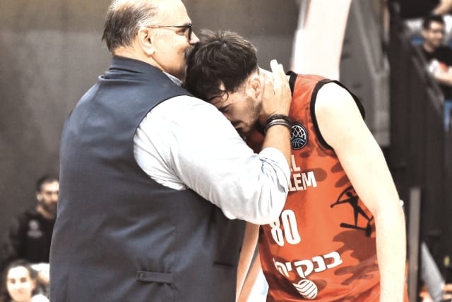  HAPOEL JERUSALEM coach Aleksandar Dzikic (left) shows some love to guard Or Cornelius during the Reds’ 64-55 Champions League victory over AEK Athens.  (photo credit: YEHUDA HALICKMAN)