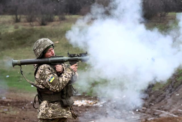  A Ukrainian serviceman with the "5 Separate Assault Brigade", fires an RPG on a training ground, amid Russia?s attack on Ukraine, in the region of Bakhmut, Ukraine, April 6, 2023. (photo credit: KAI PFAFFENBACH/REUTERS)