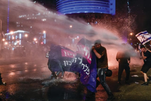  POLICE BLAST water cannons to disperse protesters in Tel Aviv, March 27. (photo credit: AVSHALOM SASSONI/FLASH90)