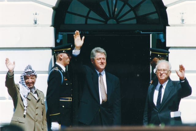  THEN-PRIME MINISTER Yitzhak Rabin, then-US President Bill Clinton and then-PLO chairman Yasser Arafat wave after the signing of the Israel-PLO Declaration of Principles, at the White House, 1993 (photo credit: GARY HERSHORN/REUTERS)