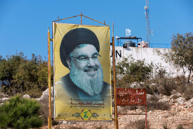  HEZBOLLAH LEADER Sayyed Hassan Nasrallah smiles smugly from a poster in Marwahin, southern Lebanon.  (photo credit: AZIZ TAHER/REUTERS)