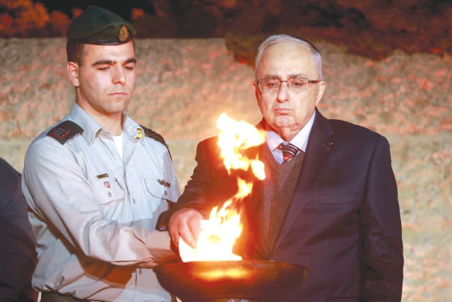  A HOLOCAUST survivor lights a torch at Yad Vashem at the state ceremony marking the beginning of Holocaust Martyrs' and Heroes' Remembrance, on Monday night (photo credit: ERIK MARMOR/FLASH90)