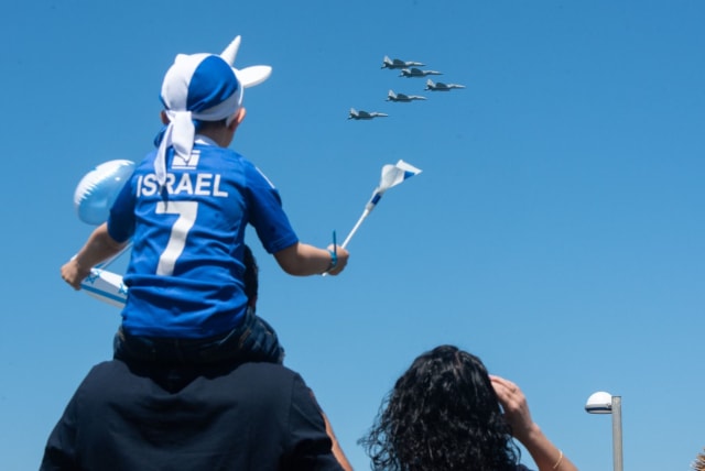  A child watches the annual Israel Independence Day flyover with his parents, April 26, 2023. (photo credit: IDF SPOKESPERSON'S UNIT)