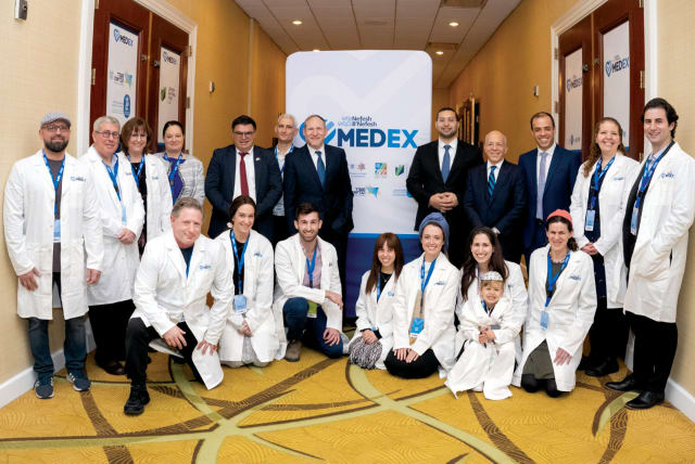  (Standing, fourth from left) Neta Katz Epstein; MK Michael Biton; Dr. Sefi Mendelovich; Rabbi Yehoshua Fass; Yitzhak Wasserlauf; Tony Gelbart; Avichai Kahana, surrounded by medical professionals at MedEx. (photo credit: NEFESH B'NEFESH)