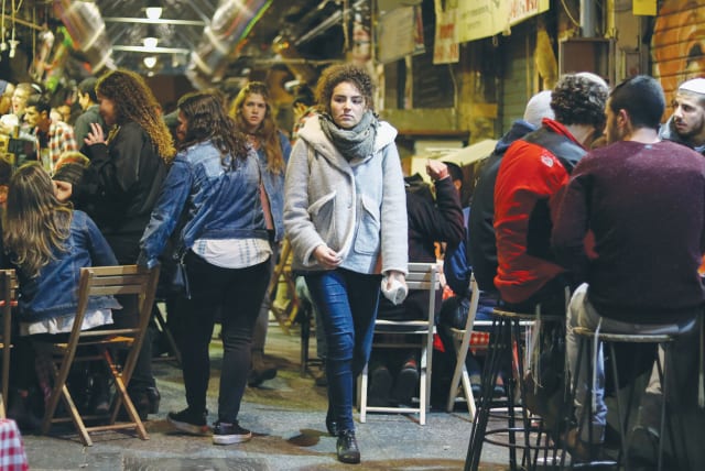  A NIGHT out at the bars of Mahaneh Yehuda in Jerusalem: Unhappy Israelis learned that they are the most joyous they’ve ever been since the index was first established 11 years ago. (photo credit: Liba Farkash/Flash90)