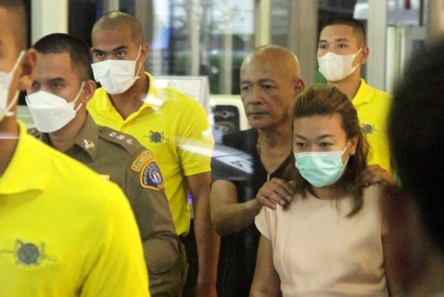  Sararat Rangsiwuthaporn, a suspect in over a dozen murders, is escorted by police officers at a police station in Bangkok (photo credit: REUTERS)