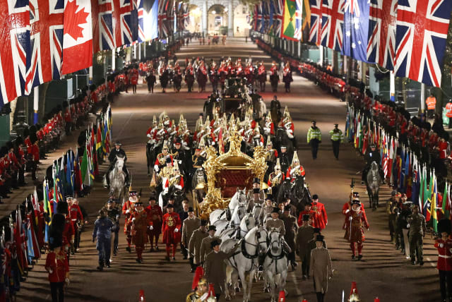  IN A full overnight coronation dress rehearsal, the Gold State Coach is ridden alongside members of the military, May 3. (photo credit: HENRY NICHOLLS/REUTERS)