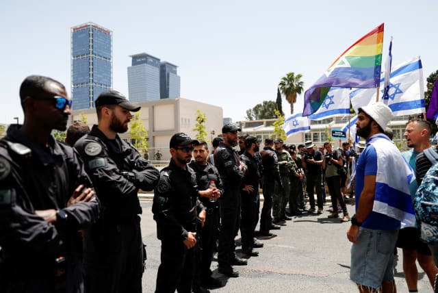  Israeli police stand in a line as protesters demonstrate on 'Day of Equality' in protest against Israeli Prime Minister Benjamin Netanyahu and his nationalist coalition government's judicial overhaul, in Tel Aviv, Israel May 4, 2023. (photo credit: CORINNA KERN/REUTERS)