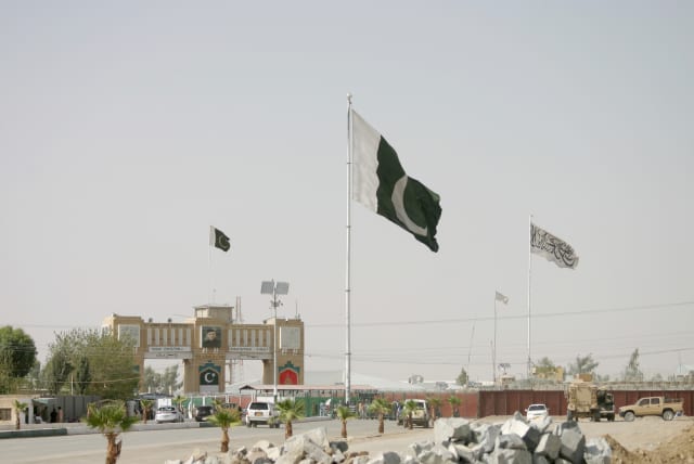  General view of Pakistan and Taliban flags at the Friendship Gate crossing point in the Pakistan-Afghanistan border town of Chaman, Pakistan August 27, 2021. (photo credit: REUTERS/SAEED ALI ACHAKZAI)